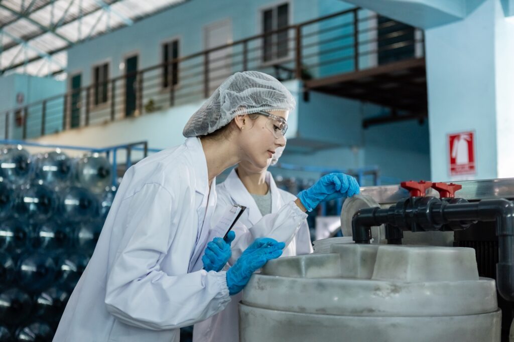 Female worker checking quality process of filtering cleanliness drinking water. management system.